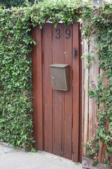 Rustic Entrance Through Vine Covered Fence