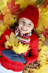 Autumn fun - girl playing in autumn leaves