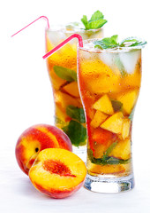 Glass of fruit iced peach Mojito cocktail with mint