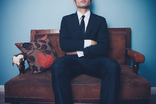 Businessman on sofa in dominant pose