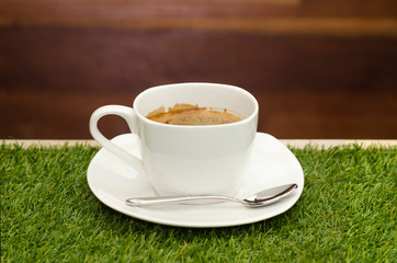 cup of coffee on green grass