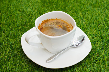 cup of coffee on green grass