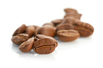 Macro of coffee beans isolated on white background