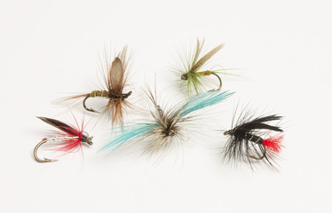 Selection of hand tied fishing flies on white