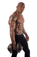 Black bodybuilder training with dumbbells. Strong man