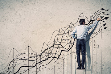 Businessman drawing graphics