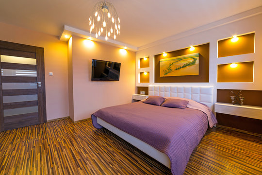 Modern brown and beige master bedroom interior