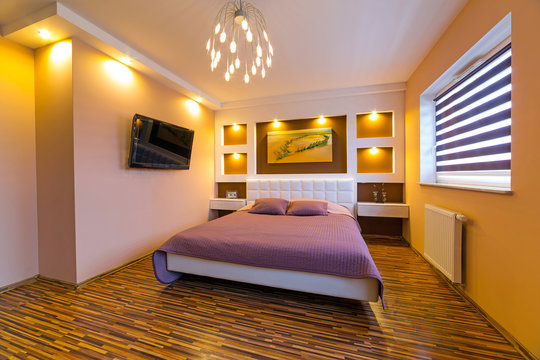 Modern brown and beige master bedroom interior