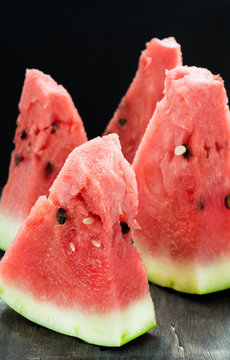 Sliced watermelon over dark background