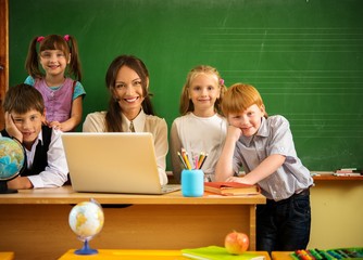 Group of happy classmates with their teacher