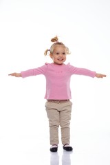 Happy little girl in pink knitted jacket