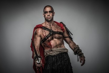 Fototapeta na wymiar Wounded gladiator with sword covered in blood