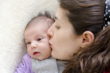 Mother kissing new born.