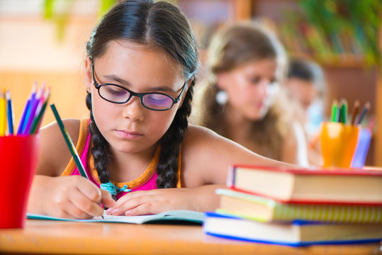 Cute Girl In Classroom At School