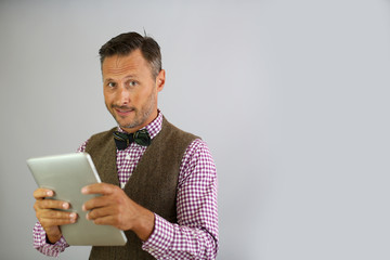 Trendy guy holding tablet on white background