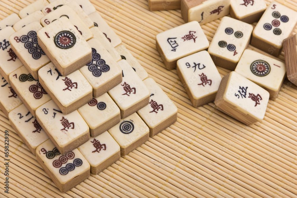 Wall mural old chinese game mahjongg on bamboo mat background