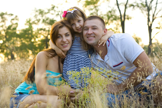 Four-year girl hugging their parents