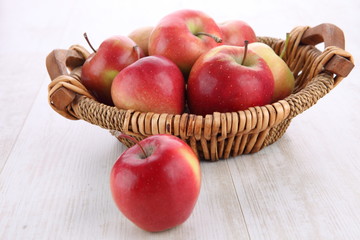 close up of basket with apples on wooden table