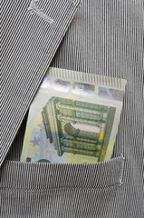 money in pocket of suit