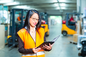 female employee or supervisor at warehouse
