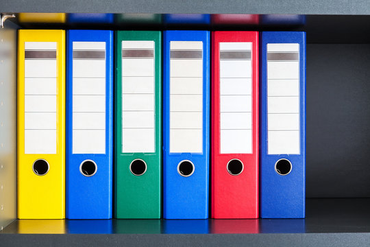 Red, green, blue and yellow office folders with boxes