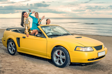 Three girls with sport car