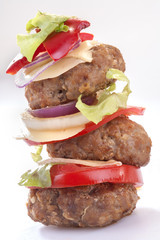 hamburgers with cheese, onion, tomato and lettuce