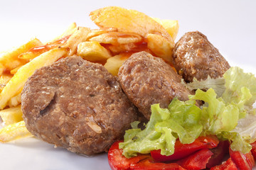 burgers with fries, salad and peppers