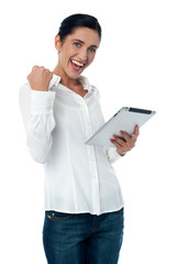 Excited pretty woman with tablet pc