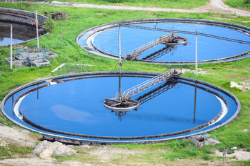 Blue water in an industrial wastewater treatment circular tanks