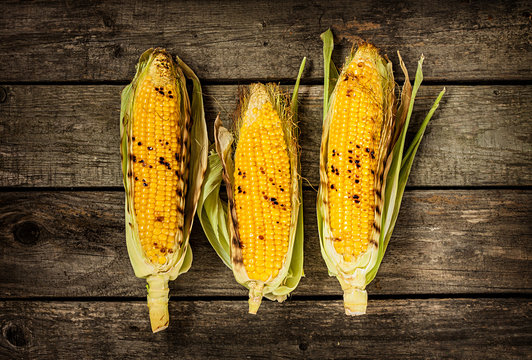 Grilled Corn Cobs On Vintage Wood Background