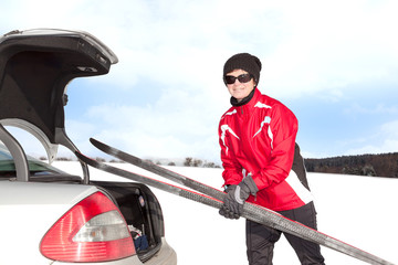 Woman with car and cross-country skis