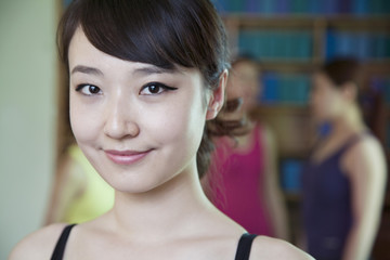 Portrait of smiling young woman in a yoga studio