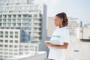 Pensive volunteer woman holding clipboard
