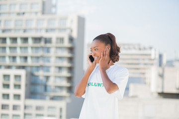 Cheerful altruist woman on the phone covering her ear