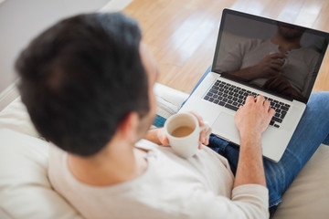 High angle view of young man using his laptop
