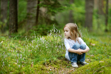 Adorable little girl hiking in the forest