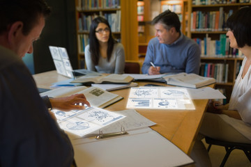 Focused mature students working on their digital tools