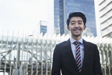 Fototapeta premium Portrait of smiling young businessman outdoors in Beijing, China