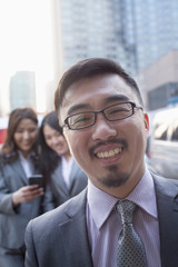 Portrait of smiling businessman outdoors, Beijing  