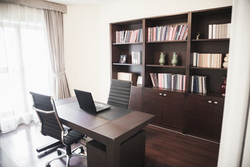 Modern home office with bookshelves.