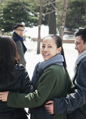 Couples in park covered in snow