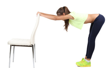 Beautiful young girl doing exercises isolated on white