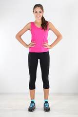 Beautiful young girl doing exercises at home