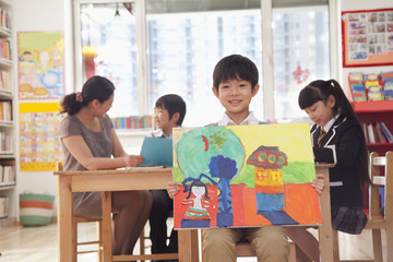 Portrait of one student holding a painting 