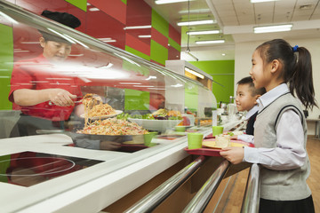 School children standing in line in school cafeteria