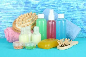 Hotel cosmetics kit on bright color background