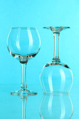 Two glasses on light blue background
