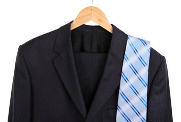 Suit and tie on hanger on white background