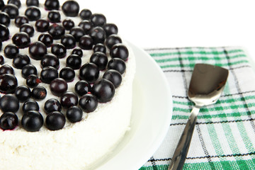 Cheesecake with fresh berries on white plate closeup